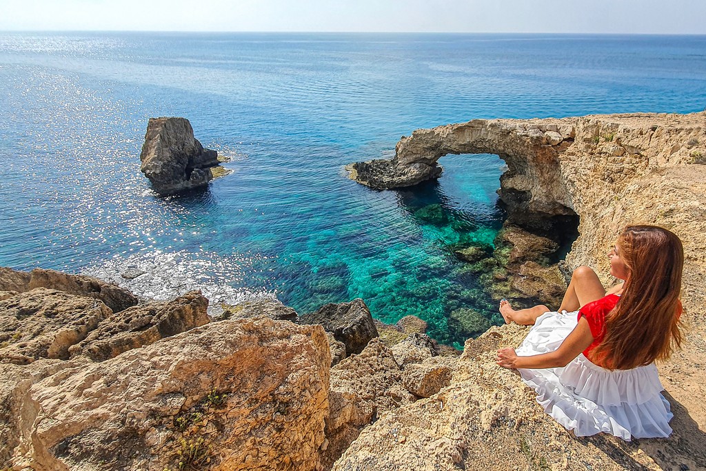 10 giorni a Cipro ragazza davanti a un arco di roccia